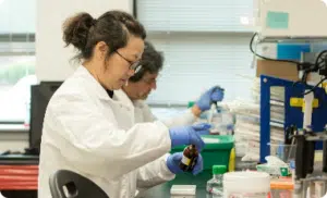 Arvinas scientific staff member preparing vials for testing