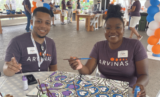Two people painting a canvas - Brining Comfort and Hope Through Art