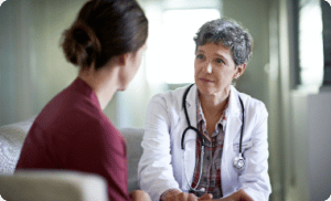 Woman conversing with female doctor