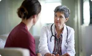 Woman conversing with female doctor