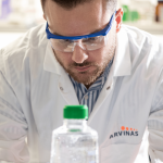 Males Arvinas scientific staff member looking down at materials